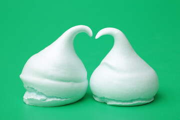 Meringue cookies on green background, horizontal picture