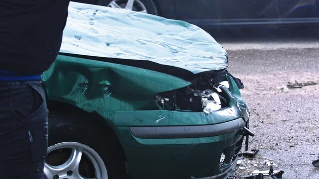 Close up, man hand breaking car lights with big hammer. High quality 4k footage