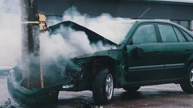 Smoke from wrecked car with fire engine in the background. Car accident. High quality 4k footage