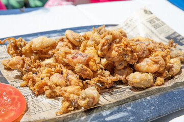 close view of tray with fried baby squids © Q