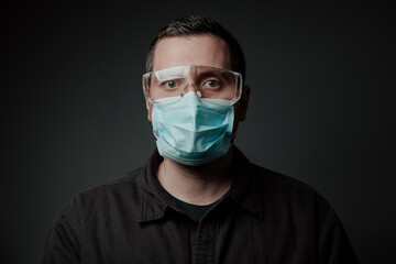 man in respirator and construction glasses