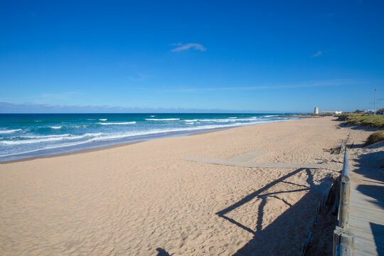 lonely Beach of Palmar with ancient tower