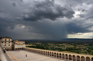 Thunderstorm approaches the courtyard of the Basilica di San Francesco, Assisi, Italy.