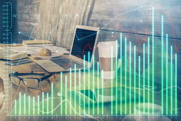 Double exposure of graph and financial info and work space with computer background. Concept of...