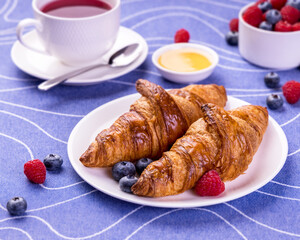 Croissants Served On A Breakfast Table With Hot Fruit Tea Raspberry Honey And Blueberry.