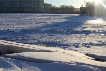 Close-up of a block of ice on a frozen river in the city on a sunny winter morning as a winter banner