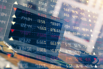 Fototapeta premium Forex market chart hologram and personal computer background. Multi exposure. Concept of investment.