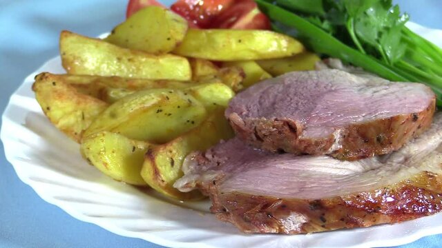 Fried pork neck with rustic potatoes and fresh vegetables
