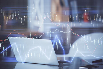 Forex market graph hologram and personal computer on background. Double exposure. Concept of investment.