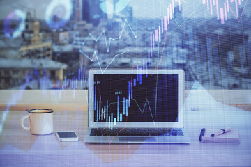 Financial graph colorful drawing and table with computer on background. Double exposure. Concept of international markets.