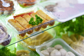 A variety of prepackaged food products in plastic boxes
