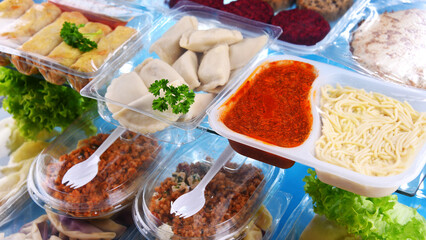 A variety of prepackaged food products in plastic boxes