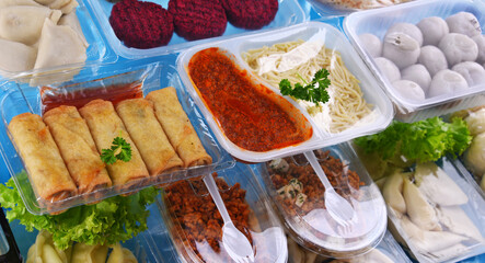 A variety of prepackaged food products in plastic boxes