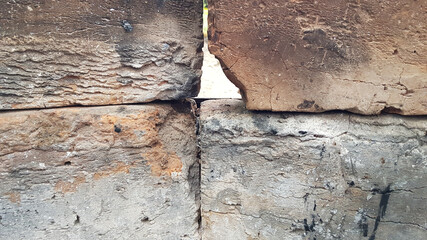 Rough surface of cracked aged bricks closeup