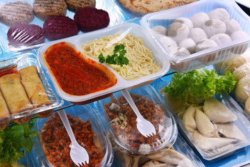 A variety of prepackaged food products in plastic boxes