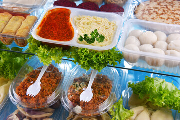 A variety of prepackaged food products in plastic boxes