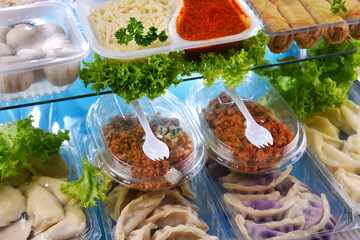 A variety of prepackaged food products in plastic boxes