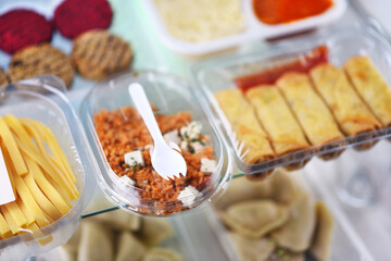 A variety of prepackaged food products in plastic boxes