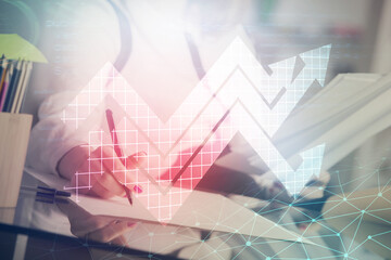 Obraz premium Blue arrow over woman's hands taking notes background. Concept of success. Double exposure