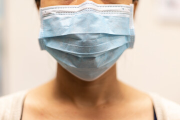 Lady wearing surgical face mask.