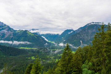 Fototapeta na wymiar Clouds are rolling through after the rain in the alps Rofan summit, Maurach, Achensee, Pertisau, Tyrol, Austria