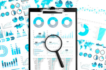 Business plan. Magnifier on clipboard with charts, documents and graphs.