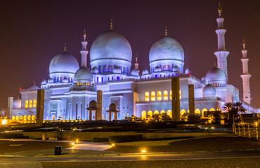 Fototapeta na wymiar Night view of domes of Grand Mosque in Abu Dhabi, UAE, also called Sheikh Zayed Grand Mosque, inspired by Persian, Mughal and Moorish mosque architecture