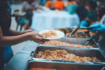 The concept of starvation : The hands of beggars receive donated food