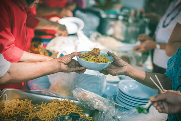 The concept of starvation : The hands of beggars receive donated food