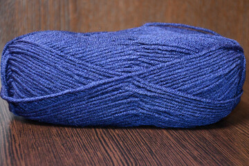 Skein blue yarn close-up on a dark brown background