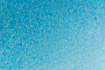 Fototapeta na wymiar blue frost on a glass background. texture patterned frosted glass.
