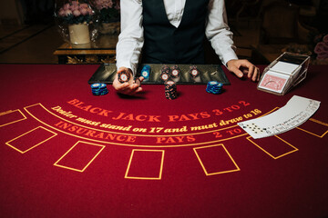 Croupier hands dealing cards on t blackjack poker table, gambling table with cards and chips - obrazy, fototapety, plakaty