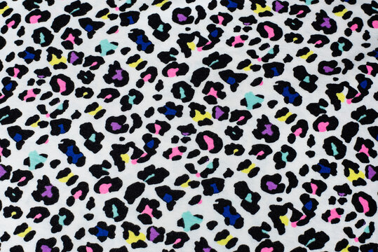 Creative background with colored and black and white spots like the skin of a Dalmatian or leopard, a beautiful fabric made like the skin of a wild animal