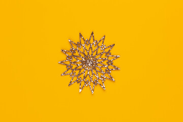 Christmas star decor on yellow colored background.