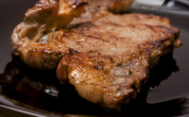 Freshly roasted meat in frying pan