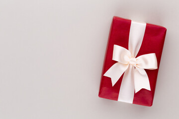Christmas gift boxes with ribbons on color tabletop.