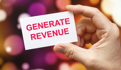 Generate Revenue - the inscription on the card that the person is holding.