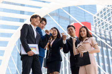 Fototapeta premium Successful young business group raise hand for celebrate.
