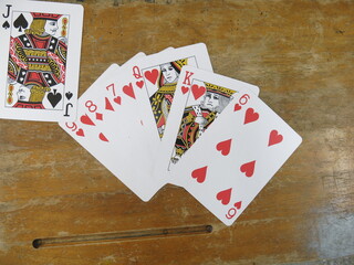 flush poker cards on the wooden table design for playing cards concept