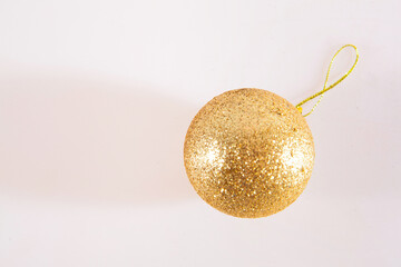 Christmas toy for the Christmas tree and new year. Beautiful gold ball isolated on the white background