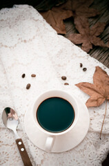 black coffee in white mug on wooden table in vintage style