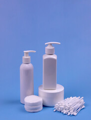 containers with cosmetics on a blue background