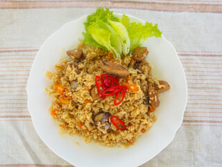 plate with pilaf, hot pepper and herbs. national cuisine. Oriental food.