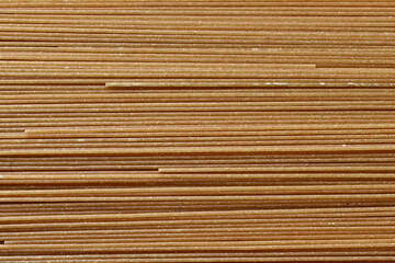 Wholegrain noodle background. Organic whole wheat spaghetti pasta, raw and dry.