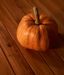 Orange pumpkin on a wooden table