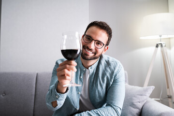 Man Drinking Red Wine In Video Conference