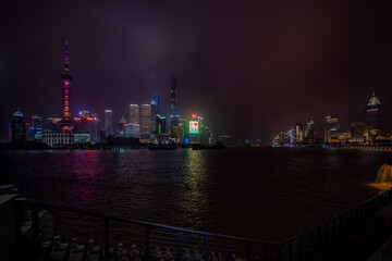 Fototapeta na wymiar A night view of the modern Pudong skyline across the Bund in Shanghai, China. Shanghai is the largest Chinese city.