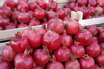 many pomegranate fruits in the wooden boxes