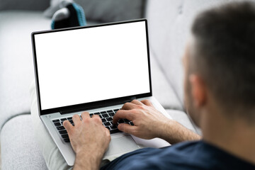 Guy Sitting On Sofa Using Laptop