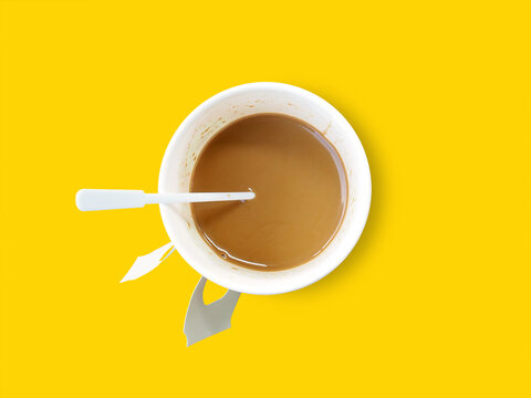 hot coffee in paper coffee cup isolated on yellow, portable cardboard mug
